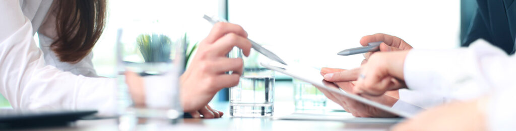 Two people discuss project documents in the Research and Development section.